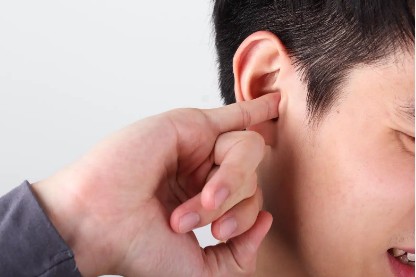 Man with finger in his ear.