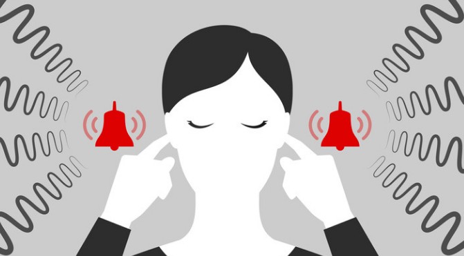woman with her fingers in her ear.